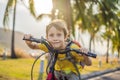 Active school kid boy riding a bike with backpack on sunny day. Happy child biking on way to school. Safe way for kids