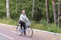 Active senior caucasian woman with gray hair is roller skating in park. Royalty Free Stock Photo