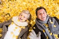 Active senior couple in autumn park lying on the ground Royalty Free Stock Photo