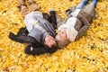 Active senior couple in autumn park lying on the ground Royalty Free Stock Photo