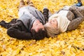 Active senior couple in autumn park lying on the ground Royalty Free Stock Photo