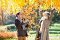 Active senior couple in autumn park throwing leaves Royalty Free Stock Photo