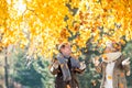 Active senior couple in autumn park throwing leaves Royalty Free Stock Photo