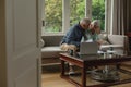 Active senior couple calculating bills in living room Royalty Free Stock Photo