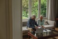 Active senior couple calculating bills in living room Royalty Free Stock Photo