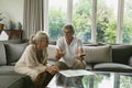 Active senior couple calculating domestic bills on sofa in living room Royalty Free Stock Photo