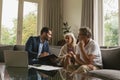 Active senior couple discussing with real estate agent over documents in living room Royalty Free Stock Photo