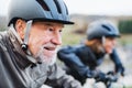 Active senior couple with electrobikes cycling outdoors on a road in nature. Royalty Free Stock Photo