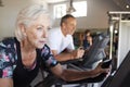 Active Senior Couple Exercising On Cycling Machines In Gym Royalty Free Stock Photo