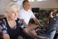 Active Senior Couple Exercising On Cycling Machines In Gym Royalty Free Stock Photo