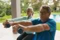 Active senior couple exercising with dumbbell in porch at home Royalty Free Stock Photo