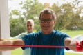 Active senior couple exercising with resistance band in porch at home Royalty Free Stock Photo