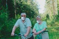 Active senior couple maintaining social distancing on bike ride in nature Royalty Free Stock Photo