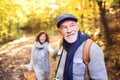 Senior couple on a walk in autumn forest. Royalty Free Stock Photo