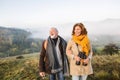 Senior couple on a walk in an autumn nature. Royalty Free Stock Photo