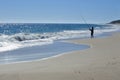 Active senior fisherman fishing on a sandy beach Royalty Free Stock Photo