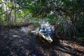 Active senior launching kayak in Coot Bay Pond in Everglades National Park.