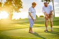 Active senior lifestyle, elderly couple playing golf together