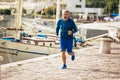 Senior man jogging on the pier on a sunny day Royalty Free Stock Photo