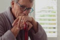 Active senior man leaning on walking cane in a comfortable home Royalty Free Stock Photo