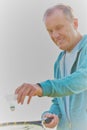 Active senior man playing badminton with tennis racket in park Royalty Free Stock Photo