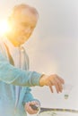 Active senior man playing badminton with tennis racket in park Royalty Free Stock Photo