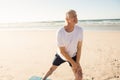 Active senior man stretching at beach Royalty Free Stock Photo