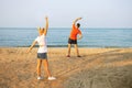 Active senior man and woman doing stretching exercises on the beach Royalty Free Stock Photo