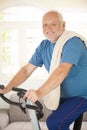 Active senior using exercise bike