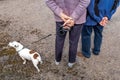 Active senior woman with dog on a walk in a nture road back view hand crossed