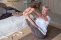 Active senior woman doing yoga training at home, holding navasana or boat yoga pose Royalty Free Stock Photo