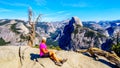 Active Senior Woman resting on a hike at Glacier Point in Yosemite National Park, California, United Sates