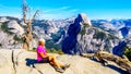 Active Senior Woman resting on a hike at Glacier Point in Yosemite National Park, California, United Sates