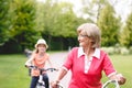 Active senior woman riding bike in a park Royalty Free Stock Photo