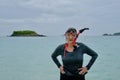 Active Senior Woman With Snorkel Gear Standing in Tropical Bay