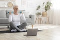 Active senior woman in sportswear exercising with dumbbells, practicing fitness at home, empty space Royalty Free Stock Photo