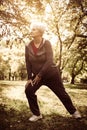 Active senior woman stretching leg and exercise in park. Royalty Free Stock Photo