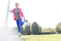 Active senior woman stretching leg in park on sunny day Royalty Free Stock Photo