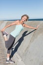 Active senior woman stretching on the pier Royalty Free Stock Photo