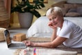 Active senior woman surfing in internet on yoga mat Royalty Free Stock Photo