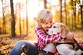 Senior woman with dog on a walk in an autumn forest. Royalty Free Stock Photo