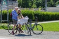 Active seniors on bikes looking at map on the streets of Berlin