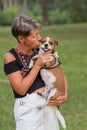 Active seniors fashion woman kissing her small dog