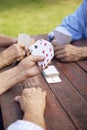 Active seniors, group of old friends playing cards at park Royalty Free Stock Photo