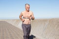 Active shirtless senior man jogging on the pier Royalty Free Stock Photo