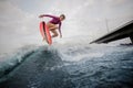 Active slim woman jumping up the blue wave against the grey sky Royalty Free Stock Photo