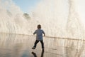 Active small kid escaping from huge water wave in city during storm weather