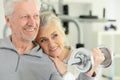 Active smiling senior couple exercising in gym Royalty Free Stock Photo