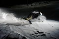 Active snowboarder riding down the snowy mountain slope at night Royalty Free Stock Photo