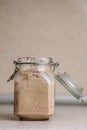 Active sourdough rye sourdough in a rustic jar. Vertical orientation, front view